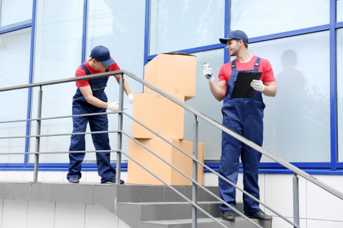 Experienced removalists loading furniture into a truck