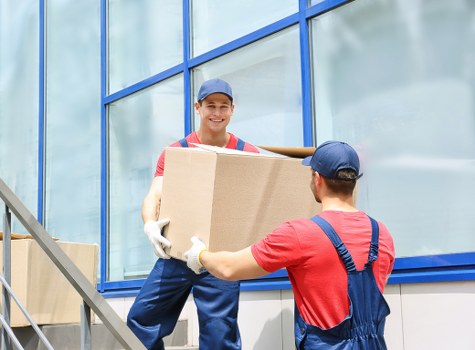 Removalists packing household items carefully